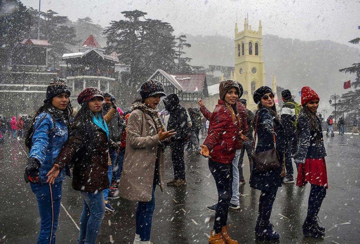 Tourists enjoy fresh snowfall, in Shimla, Sunday, Jan 27, 2019. (PTI Photo)