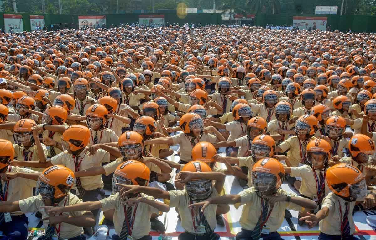 School students wear helmets during a Guinness Record attempt to spread awareness on road safety measures, organised by ICICI Lombard through its CSR initiative ‘Ride To Safety’, in Mumbai, Thursday, Jan 31, 2019. (PTI Photo)