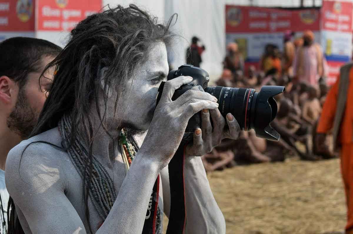 A 'Naga Sadhu' shoots a photo during Kumbh Mela 2019, in Allahabad (Prayagraj), Friday, Feb 1, 2019. (PTI Photo)