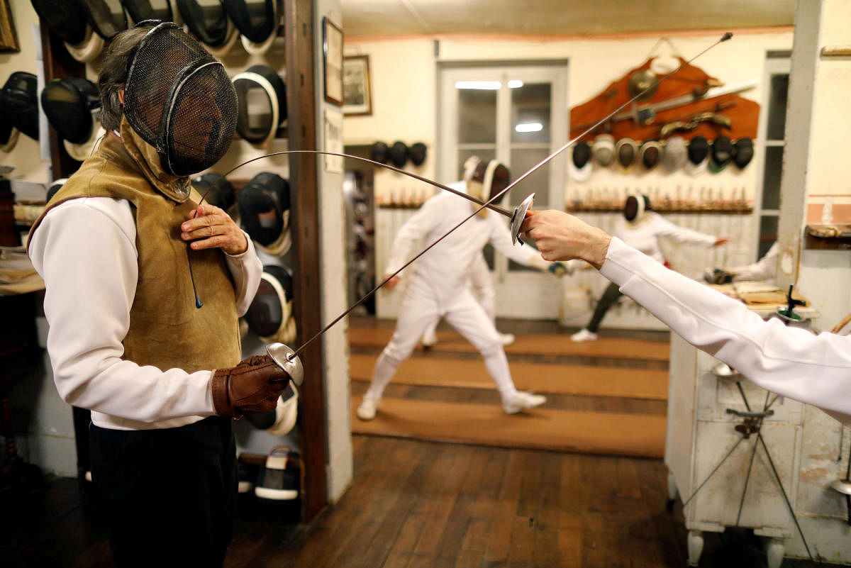 Master Jean-Pierre Pinel La Taule conducts a training session at the Salle d’Armes Coudurier in the Quartier Latin in central Paris, France, January 28, 2019. This oldest fencing club in Paris, founded in 1886, is a small Salle d'Armes (weapons room) which has remained intact since its creation and which was bought by Master Jean-Pierre Pinel La Taule in 1971, keeping the name, the tradition, the spirit, the honour and the teaching, just as it was in the beginning. Picture taken January 28, 2019. REUTERS/Charles Platiau