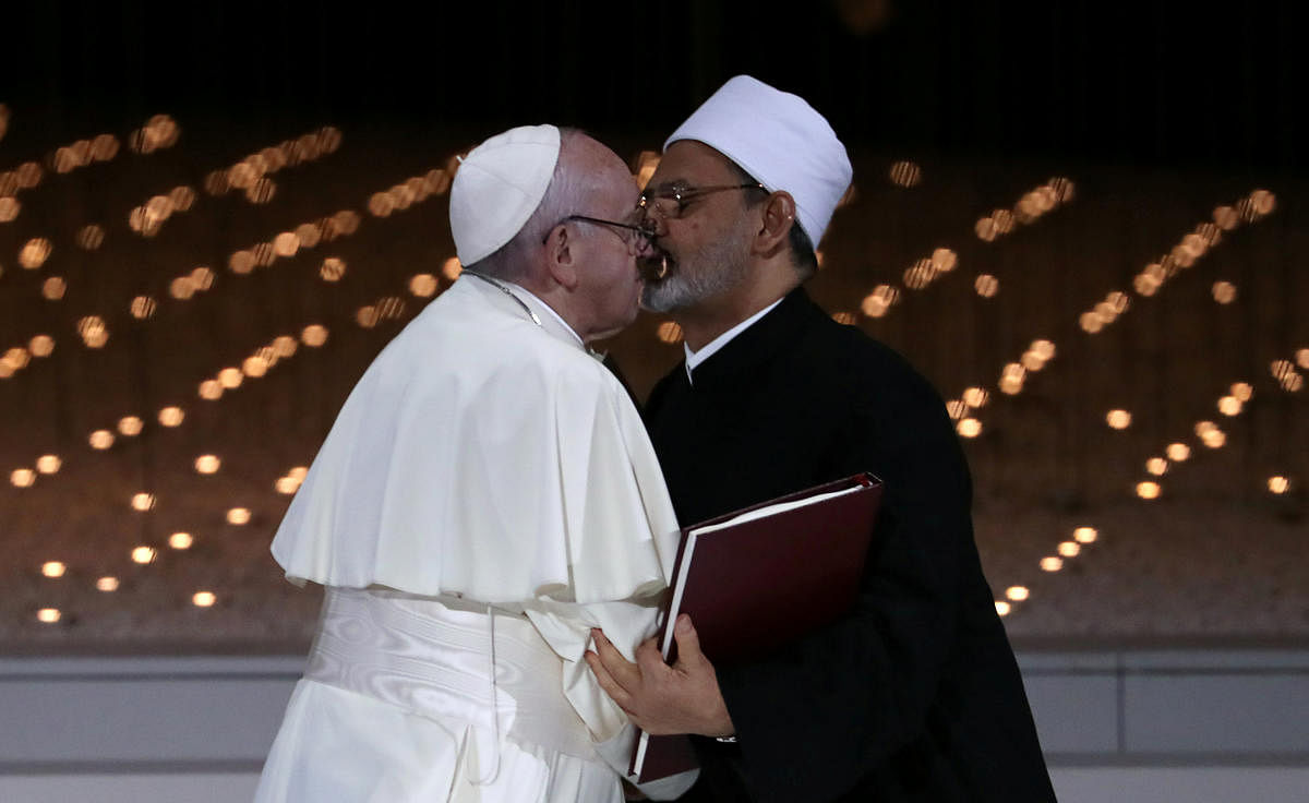 Pope Francis and Grand Imam of al-Azhar Sheikh Ahmed al-Tayeb kiss each other after signing a document on fighting extremism, during an inter-religious meeting at the Founder's Memorial in Abu Dhabi, United Arab Emirates, February 4, 2019. REUTERS/Tony Gentile