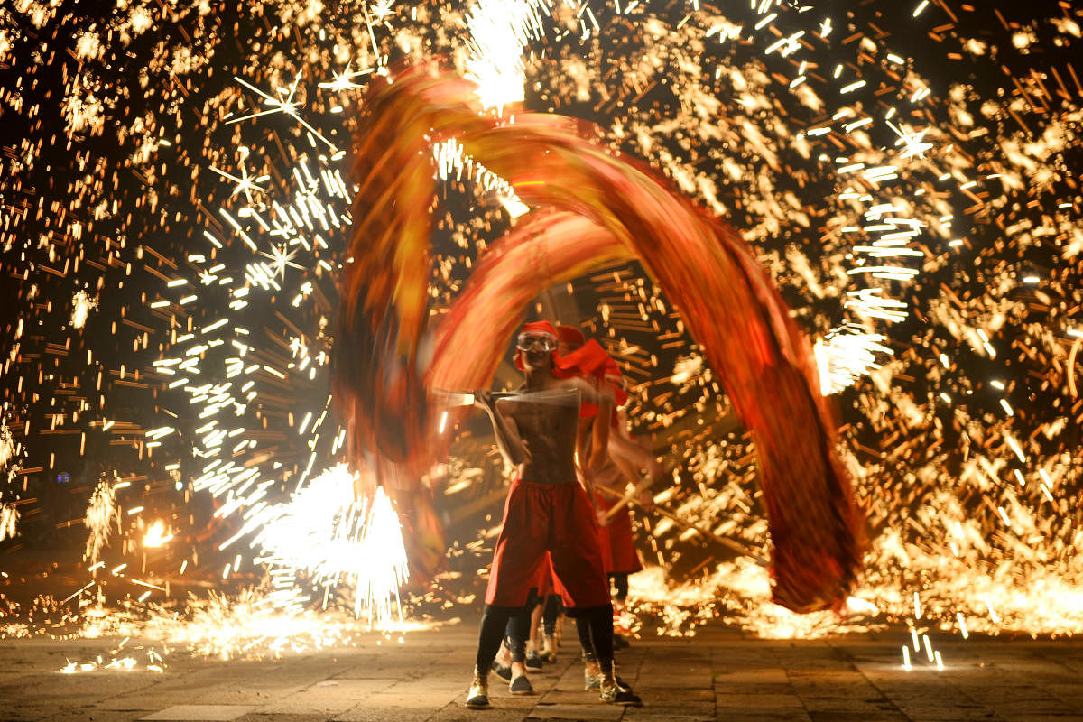 Performers take part in a fire dragon dance under a shower of molten iron sparks on the first day of the Chinese Lunar New Year of the Pig, in Zaozhuang, Shandong province, China February 5, 2019. Picture taken February 5, 2019. REUTERS/Stringer