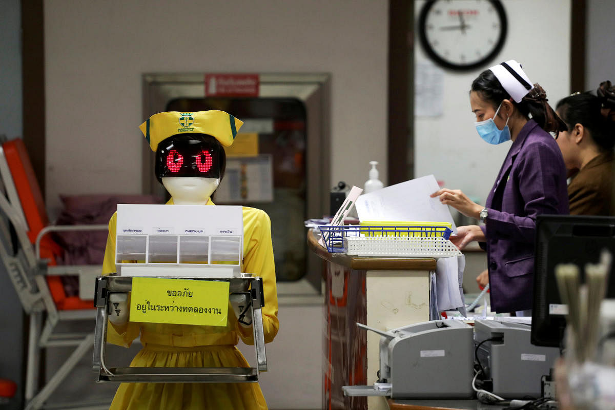 A robot wearing a nurse costume carries medical documents at Mongkutwattana General Hospital in Bangkok, Thailand, February 6, 2019. REUTERS/Athit Perawongmetha