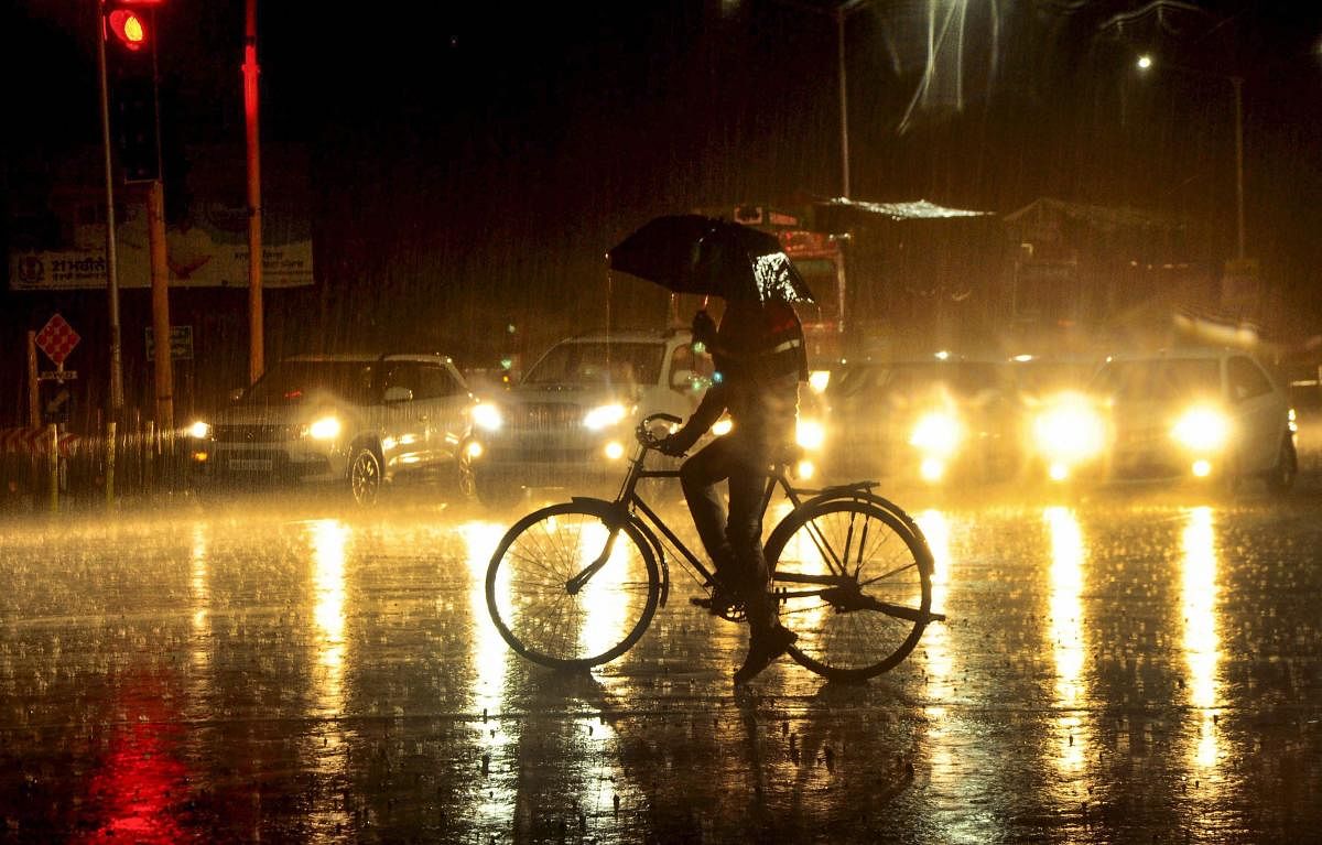 A silhouette of a cyclist seen during heavy rainfall, in Patiala, Thursday, Feb 7, 2019. (PTI Photo)
