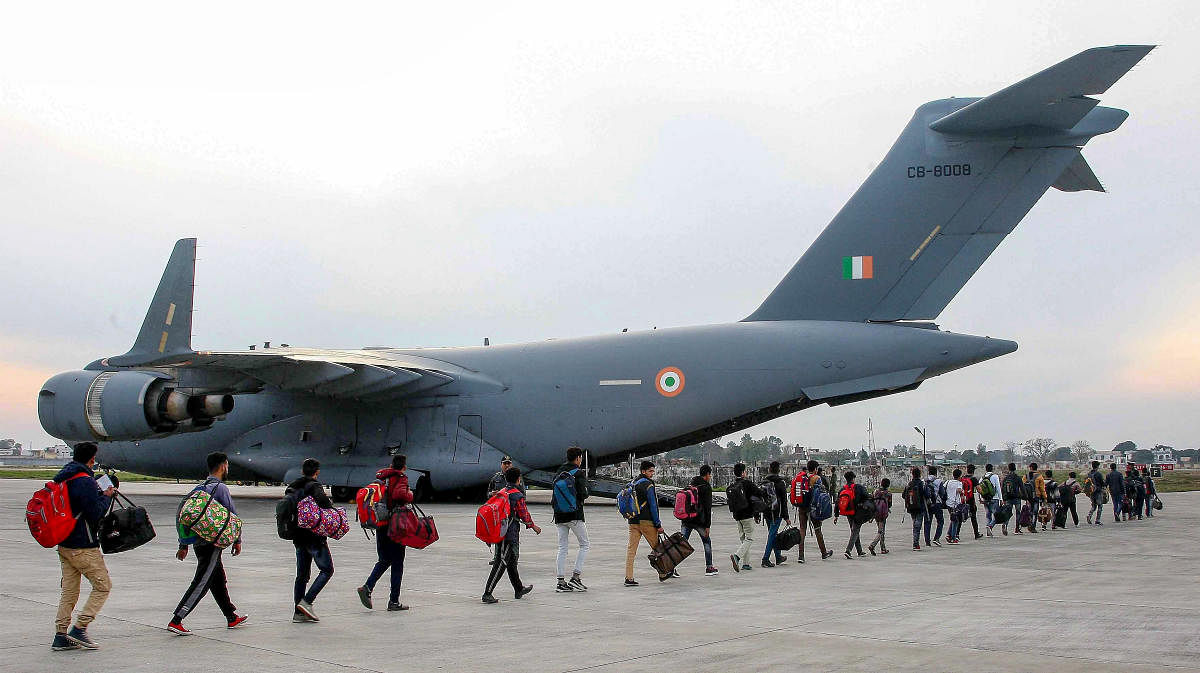 Stranded Kashmir bound passengers queue up to board a C-17 aircraft of the Indian Air Force for the valley, in Jammu, Monday, Feb 11, 2019. (PTI Photo)