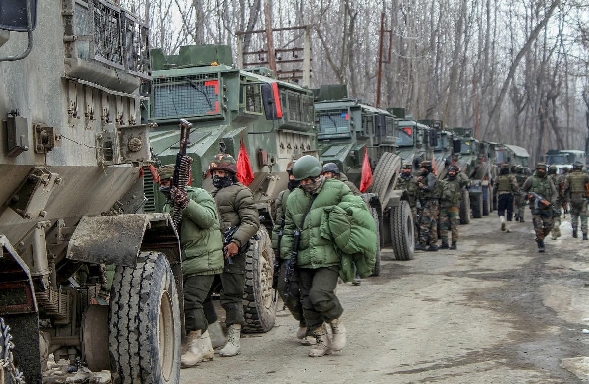 Army soldiers near the house where militants were hiding during an encounter in Ratnipora area of Pulwama district of south Kashmir, Tuesday, Feb 12, 2019. One army soldier and one militant were killed in the encounter. (PTI Photo)