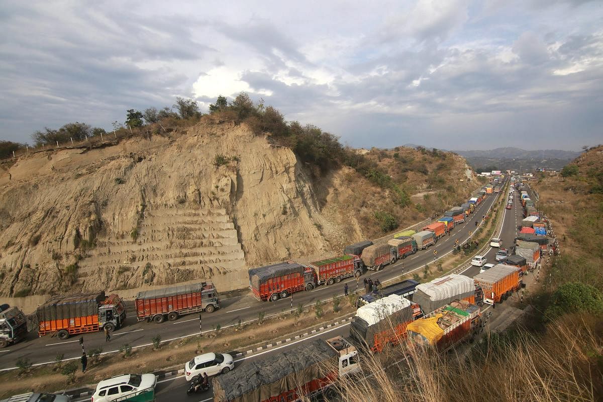 Stranded vehicles wait for the Jammu-Srinagar national highway to open, on the outskirts of Jammu, Wednesday, Feb 13, 2019. One way traffic from Jammu on the highway connecting Srinagar was allowed on Wednesday, a day after the strategic road linking Kashmir with rest of the country was cleared of snow, officials said. (PTI Photo)