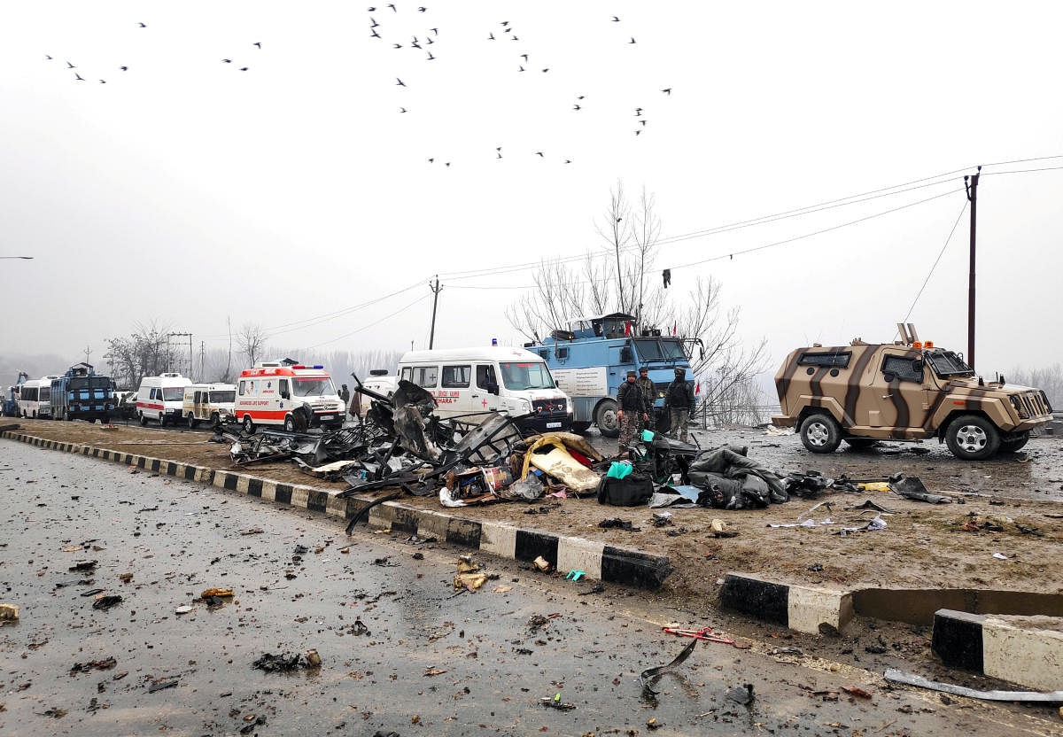 Indian soldiers examine the debris after an explosion in Lethpora in south Kashmir's Pulwama district February 14, 2019. REUTERS