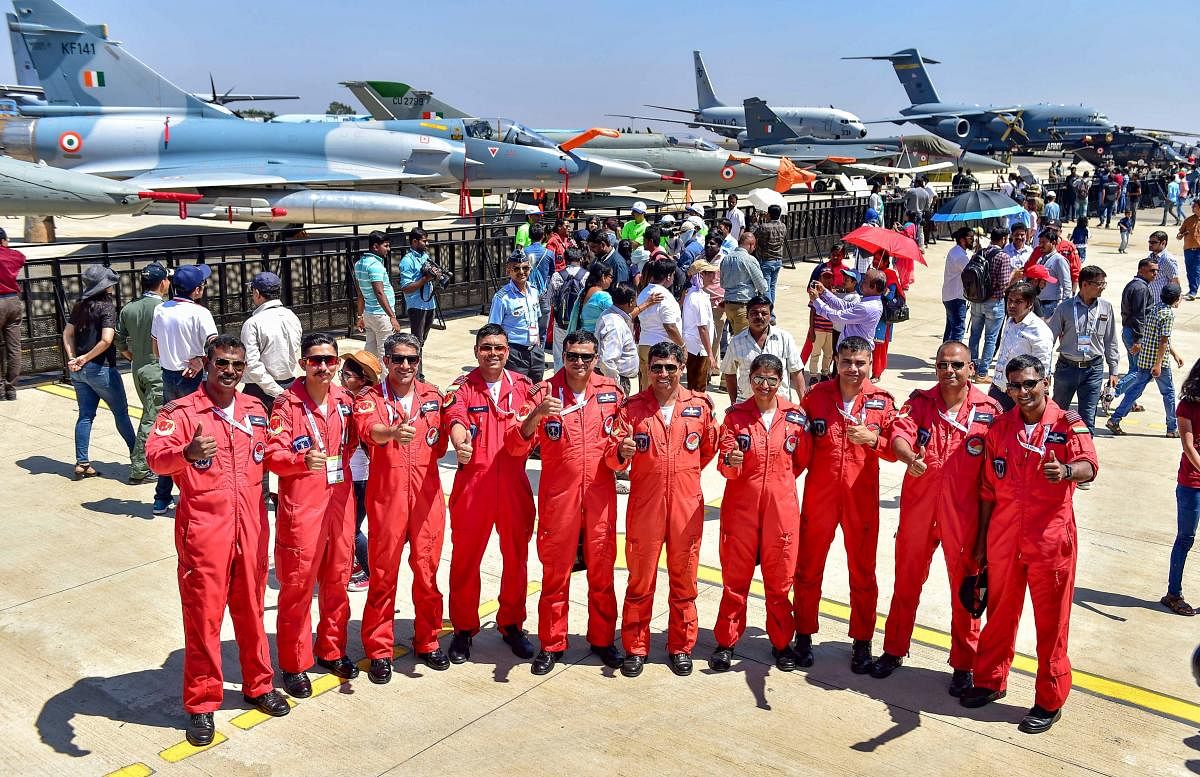 IAF's Sarang display team pilots pose for photograph during a rehearsal for the 12th edition of AERO India 2019 at Yelahanka airbase in Bengaluru, Monday, Feb 18, 2019. (PTI Photo)