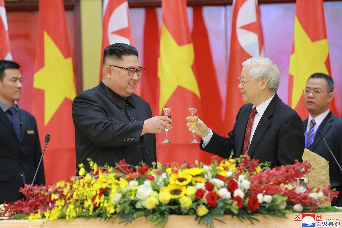 North Korean leader Kim Jong Un, center left, and Vietnamese President Nguyen Phu Trong toast during dinner in Hanoi, Vietnam. The content of this image is as provided and cannot be independently verified. AP/PTI