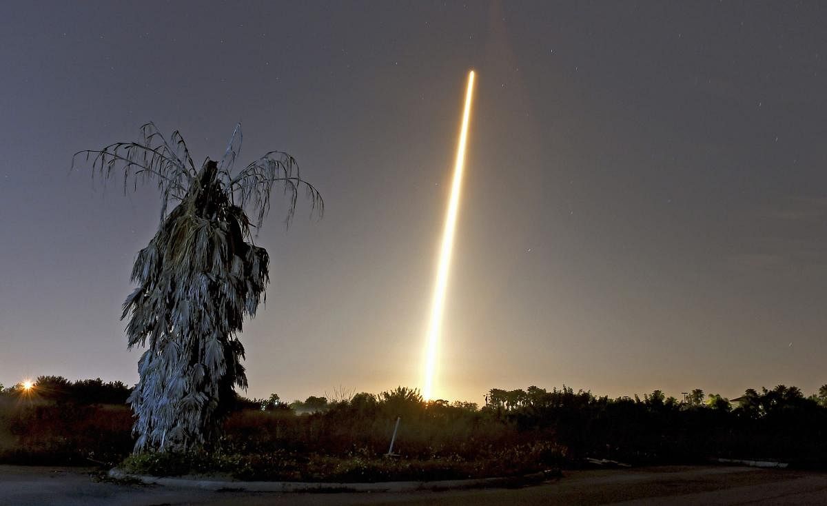 The SpaceX Falcon 9 rocket and Crew Dragon capsule launch from NASA pad 39A as seen in a time exposure from Viera, FL. on March 2 with a lone, untrimmed palm tree in the foreground. AP/PTI