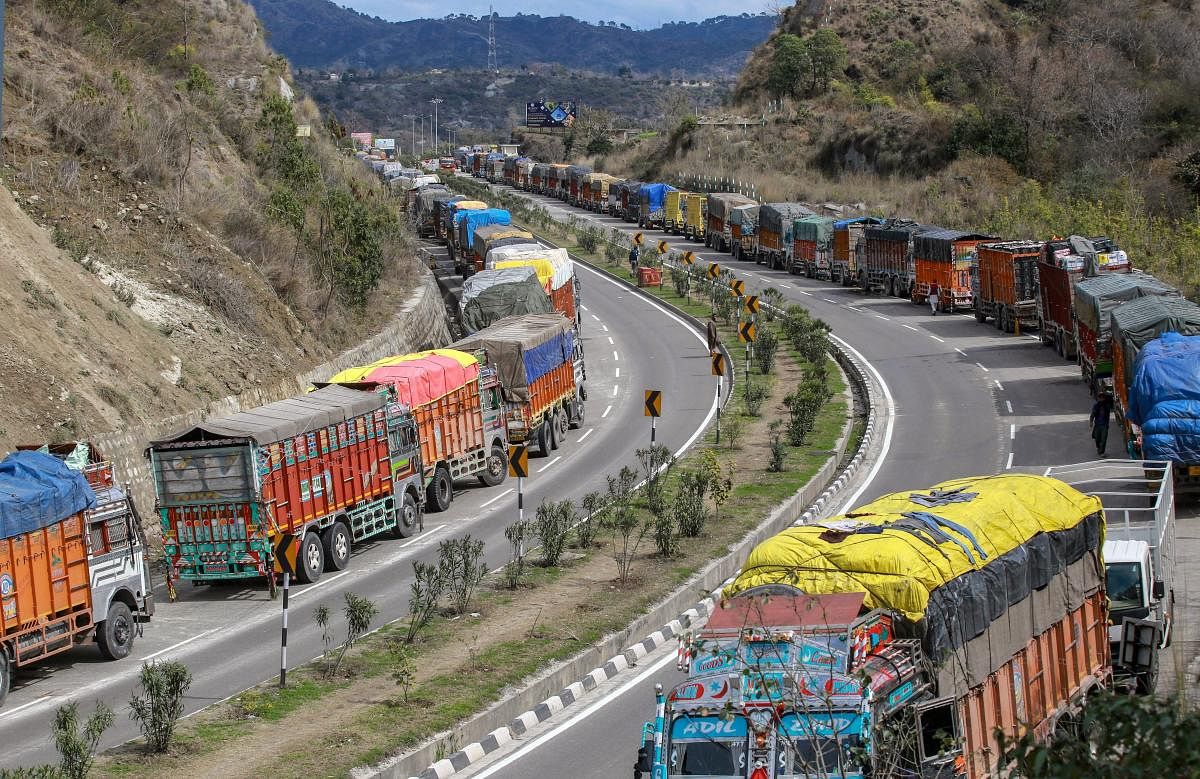 A queue of stranded trucks on Jammu-Srinagar highway, which is closed due to heavy rain and landslides, at Nagrota on the outskirts of Jammu. PTI Photo
