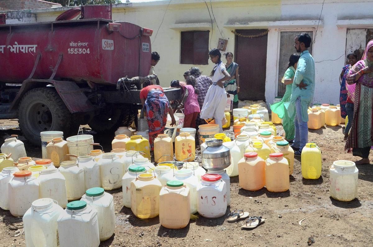 Bhopal: People fetch drinking water from a Municipal Corporation's water tanker due to short supply at the onset of summer, in Bhopal, Saturday, March 9, 2019. (PTI Photo)
