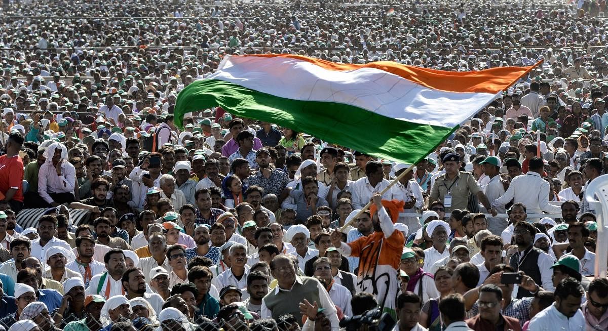 Gandhinagar: Congress supporters wave the tricolour as they cheer during the party's public rally, in Gandhinagar, Tuesday, March 12, 2019. (PTI Photo)