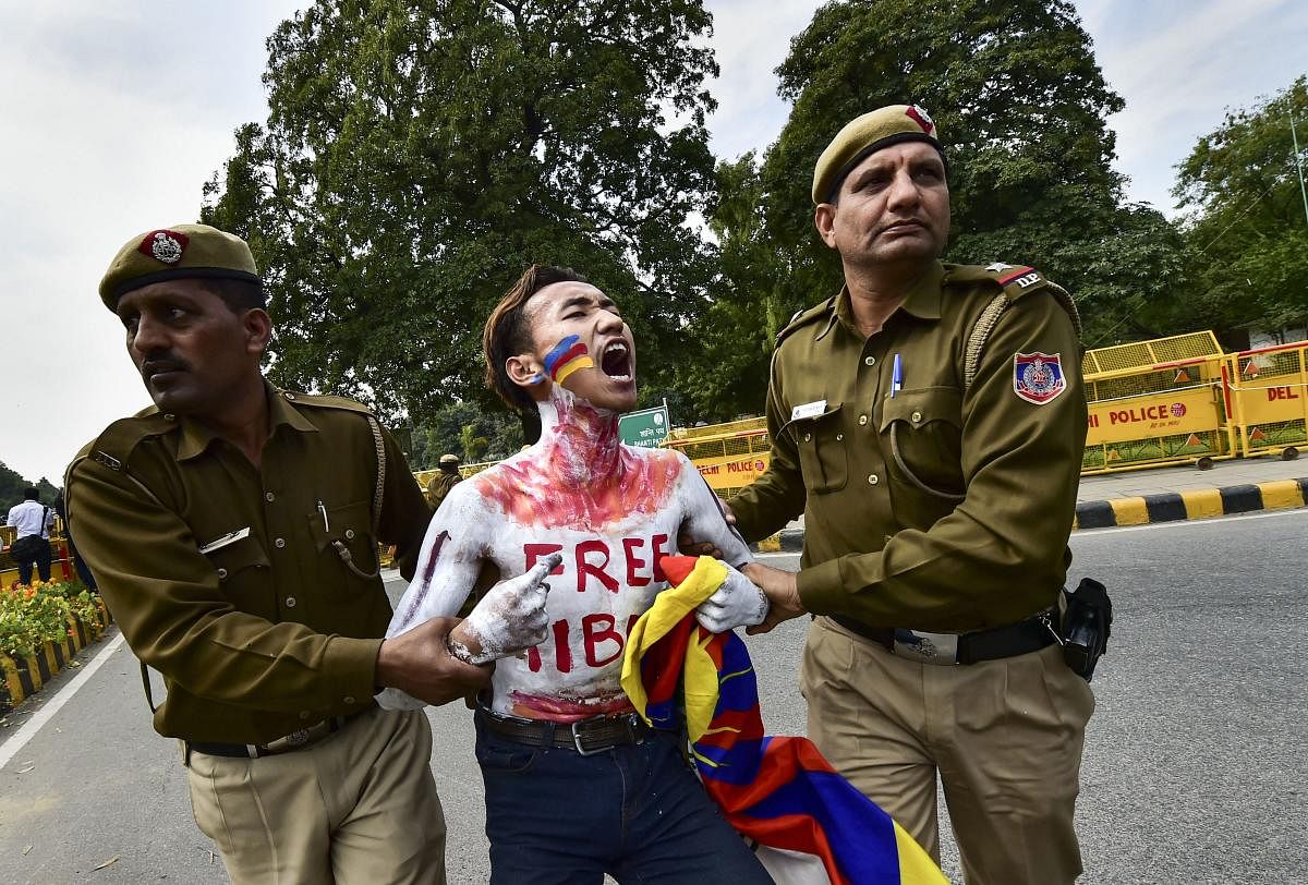 Police personnel detain Tibetan activists during their protest to commemorate the anniversary of 1959 Tibetan uprising against Chinese rule, near the Chinese embassy in New Delhi, Tuesday, March 12, 2019. (PTI Photo/Arun Sharma)