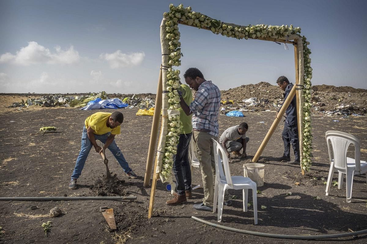 Workers erect floral installations at the scene where the Ethiopian Airlines Boeing 737 Max 8 crashed shortly after takeoff on Sunday killing all 157 on board, near Bishoftu, or Debre Zeit, south of Addis Ababa, in Ethiopia Wednesday, March 13, 2019. AP/PTI