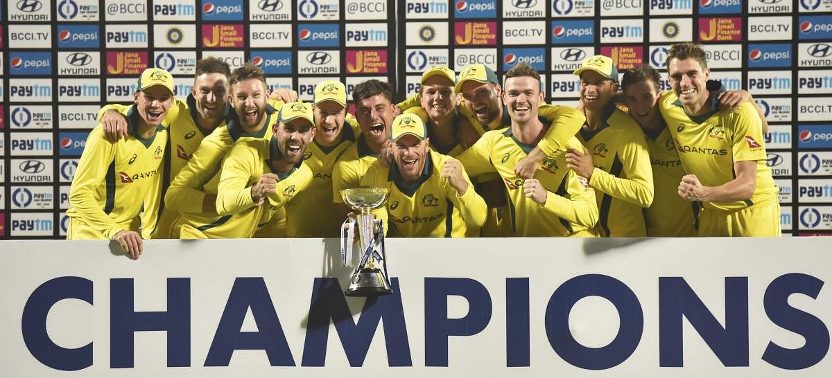 Australian cricketers pose with trophy after winning the fifth One-Day International (ODI) cricket match and series against India at the Feroz Shah Kotla Ground, in New Delhi, Wednesday, March 13, 2019. (PTI Photo/Ravi Choudhary)