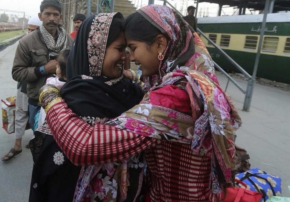 A Pakistani woman, left, receives her Indian relative who arrives at Lahore railway station in Pakistan, Thursday, March 14, 2019. Officials from India and Pakistan met Thursday amid easing tensions to discuss opening a visa-free border crossing to allow pilgrims to easily visit a Sikh shrine just inside Pakistan. AP/PTI