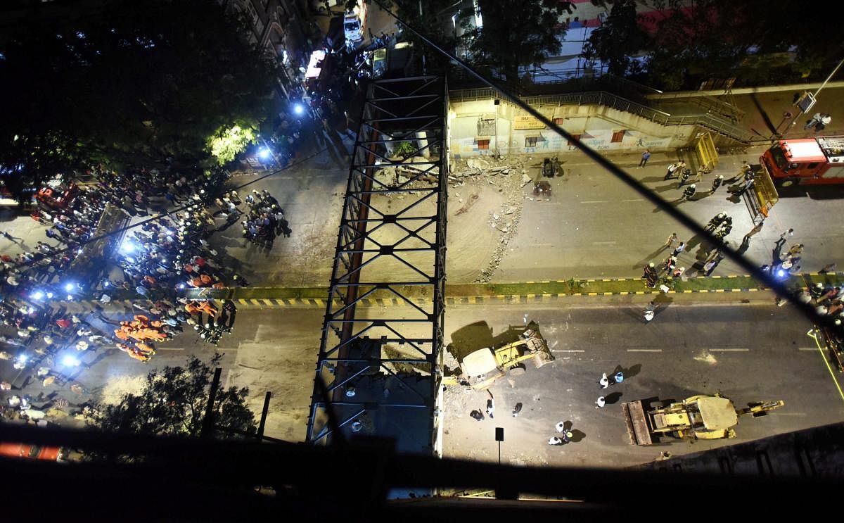 A general view shows a part of the partially collapsed foot overbridge near a train station in south Mumbai, Thursday, March 14, 2019. The bridge connected the bustling Chhatrapati Shivaji Maharaj Terminus railway station with the Azad Maidan Police Station. (PTI Photo)