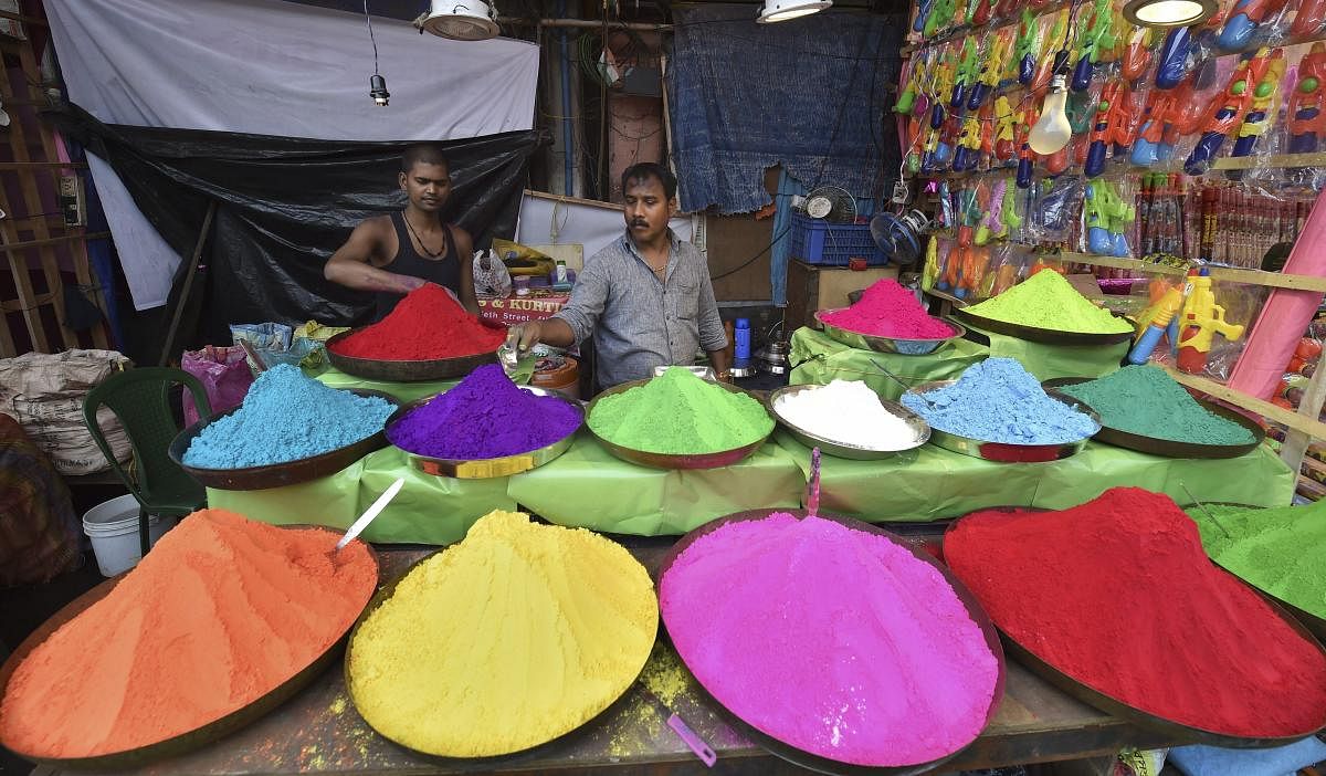 A seller arranges different colours of 'Gulal' at a roadside shop ahead of the upcoming 'Holi' festival, in Kolkata, Thursday, March 14, 2019. (PTI Photo/Swapan Mahapatra)