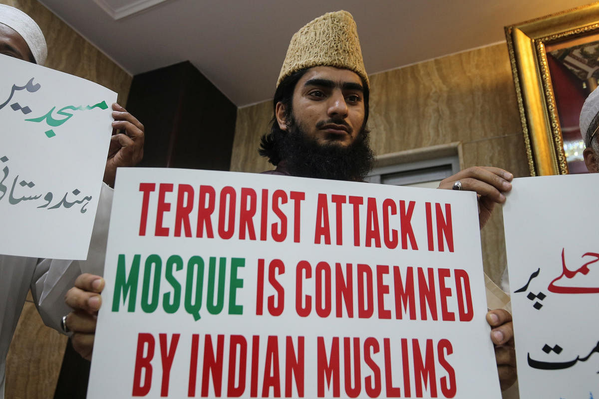 A man holds a placard to condemn Christchurch mosque attack in New Zealand, at a madrasa in Mumbai. (Reuters Photo)