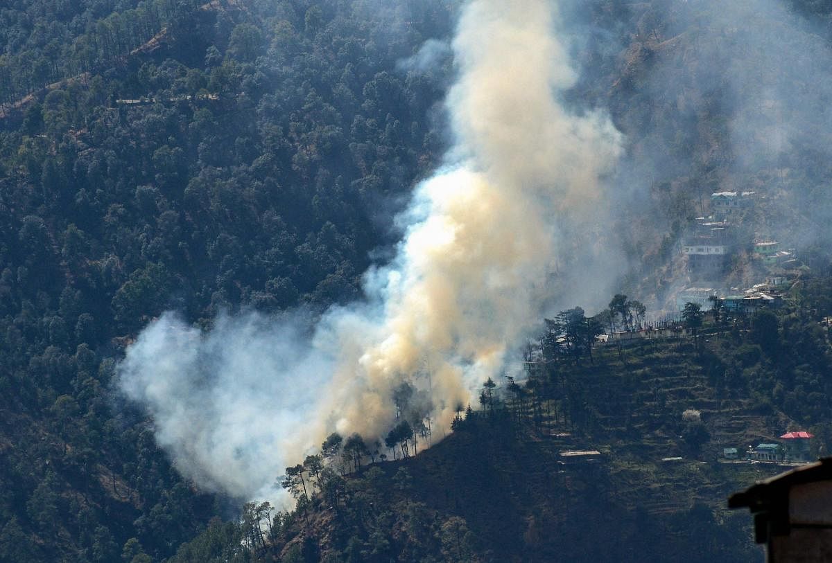 Smoke rises from a forest fire that broke out near Taradevi temple, in Shimla. (PTI Photo)