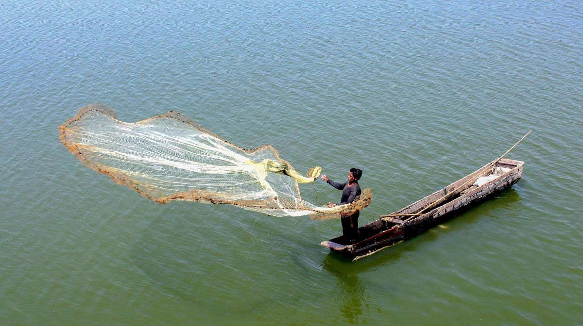 A fisherman casts his net at at Upper Lake, in Bhopal, Friday, March 22, 2019. World Water Day is celebrated every year on March 22. (PTI Photo)