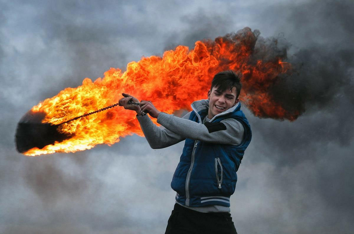 A young man spins a burning tire on a metal chain, during a ritual marking the upcoming Clean Monday, the beginning of the Great Lent, 40 days ahead of Orthodox Easter, on the hills surrounding the village of Poplaca, in central Romania's Transylvania region. PTI