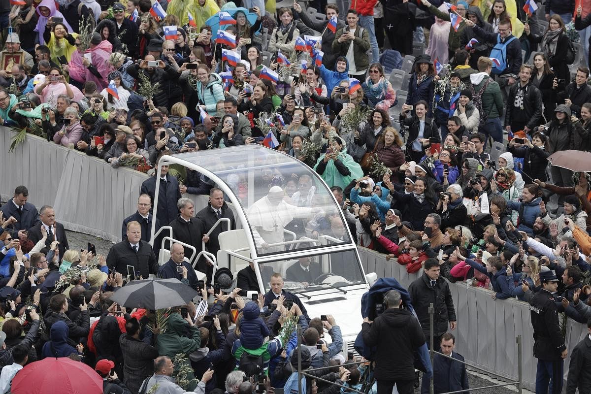 Vatican City: Pope Francis waves to faithful as he leaves St. Peter's Square on the popemobile, at the Vatican, Sunday, April 14, 2019. AP/PTI