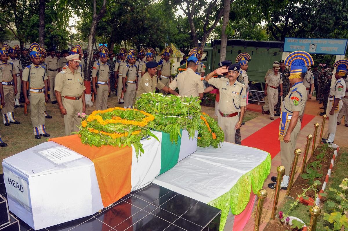 A senior officer pays tribute to Central Reserve Police Force (CRPF) jawan Bishwajit Chouhan who was killed in an encounter with the Maoists, at a ceremony at 133 CRPF battalion headquarter in Ranchi, Monday, April 15, 2019. PTI