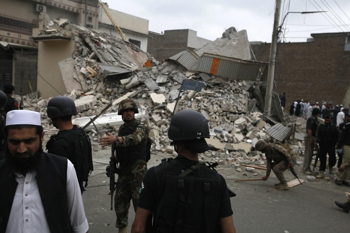 Pakistani security forces demolish the hideout of militants in Peshawar, Pakistan, Tuesday, April 16, 2019. Pakistani authorities say a raid by security forces on a militant hideout in the northwestern city of Peshawar triggered a 15-hour shootout in which a police officer and many suspected militants were killed. AP/PTI