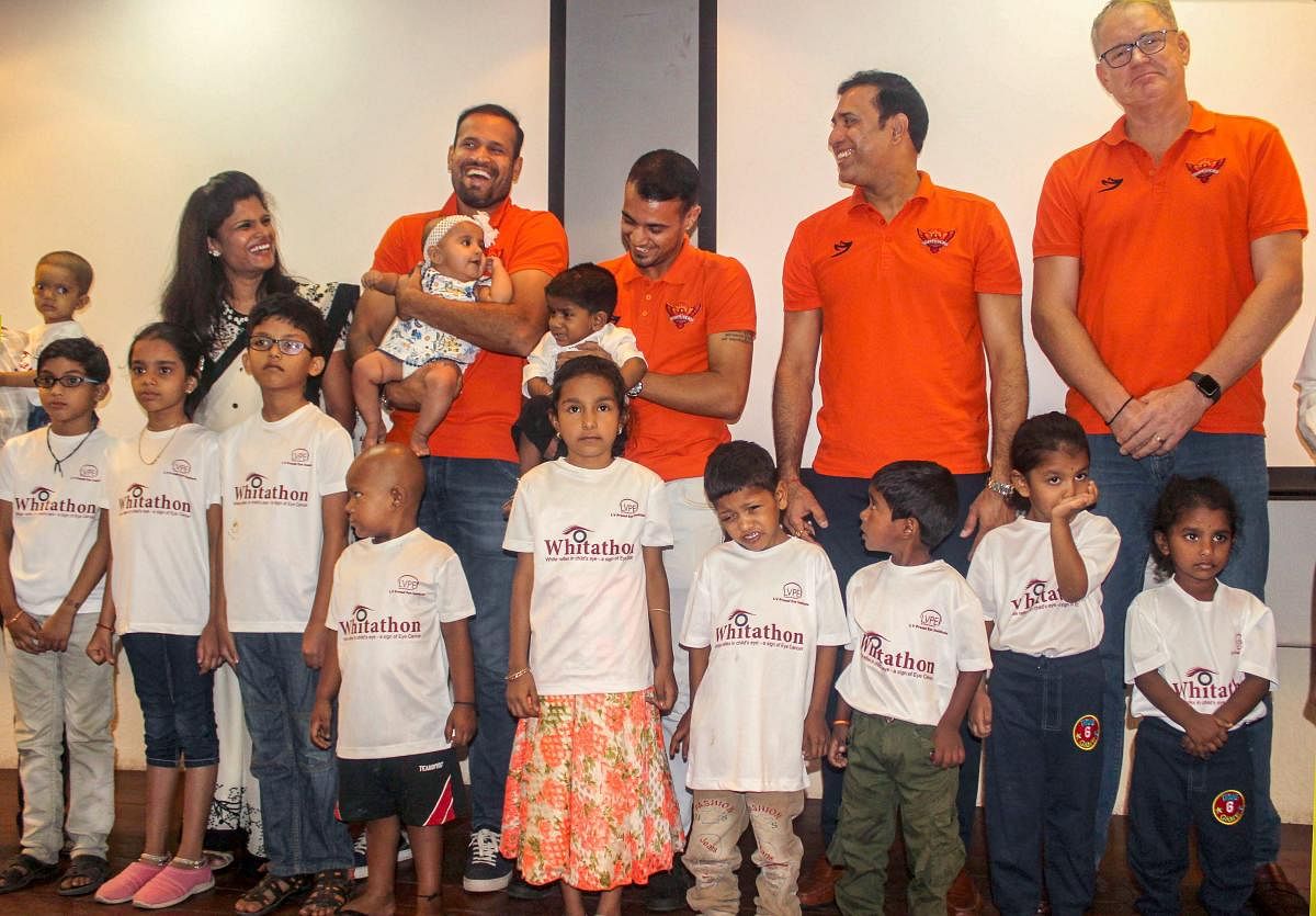 Sunrisers Hyderabad's Yusuf Pathan, Siddharth Kaul, VVS Laxman and Tom Moody interact with children suffering from Eye Cancer as they unveil the t-shirts of 'Whitathon 2019', in Hyderabad, Tuesday, April 16, 2019. PTI
