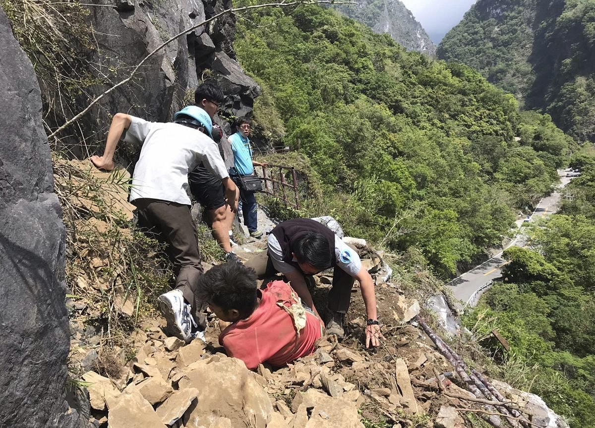 Hualien: In this photo released by Taroko National Park, an injured Malaysian tourist, in red, is assisted by rescue workers at the Taroko National Park in Hualien in eastern Taiwan Thursday, April 18, 2019. A strong earthquake rattled eastern Taiwan early Thursday afternoon, causing scattered light damage in the capital and the eastern coast region. AP/PTIHualien: In this photo released by Taroko National Park, an injured Malaysian tourist, in red, is assisted by rescue workers at the Taroko National Park in Hualien in eastern Taiwan Thursday, April 18, 2019. A strong earthquake rattled eastern Taiwan early Thursday afternoon, causing scattered light damage in the capital and the eastern coast region. AP/PTI