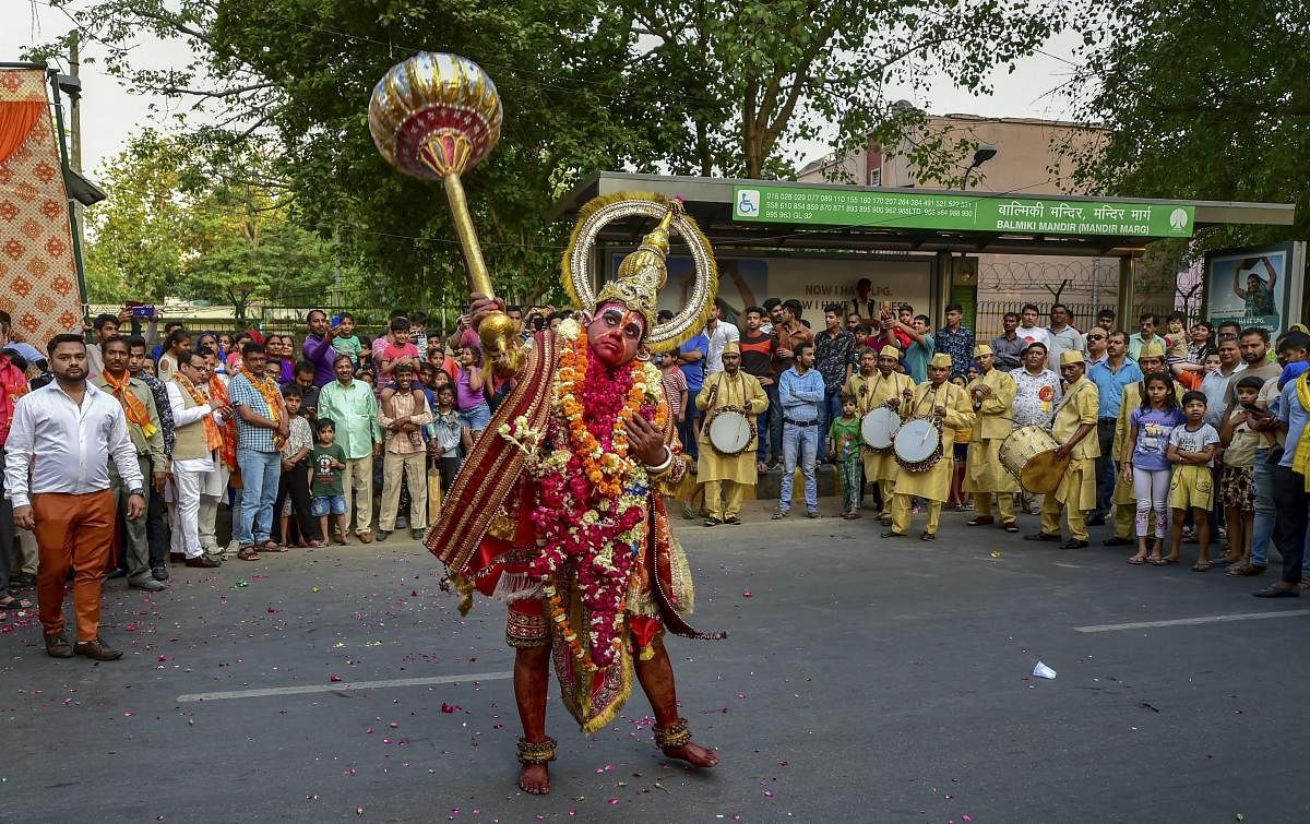 An artist dressed as Lord Hanuman takes part in a religious procession on the occasion of Hanuman Jayanti, in New Delhi, Friday, April 19, 2019. (PTI Photo/Arun Sharma)