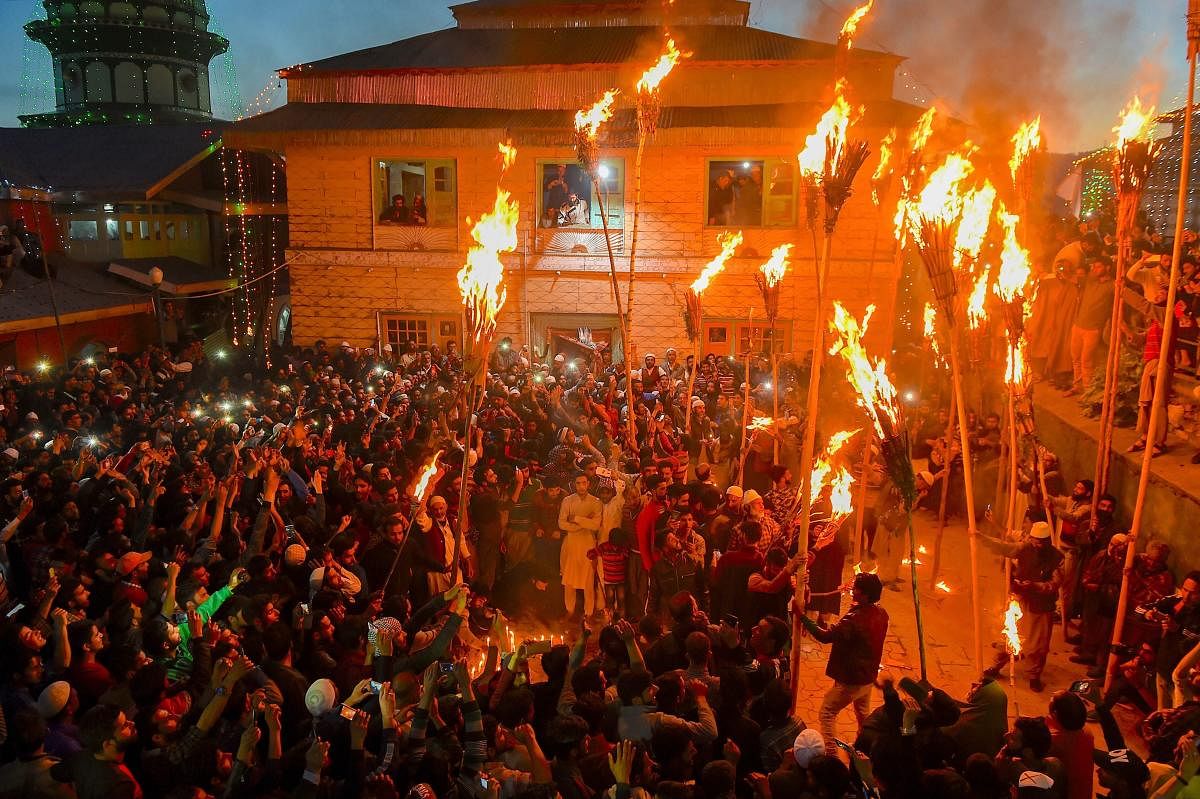 Aishmuqam: Villagers perform traditional 'Dambali' during the 'Zool' festival on the occasion of the annual urs at the shrine of Sofi saint Hazrat Zain-u-Din Wali, at Aishmuqam Anantnag district of South Kashmir, Friday, April 19, 2019. The festival is celebrated by the villagers as victory of good over evil. (PTI Photo/S. Irfan)