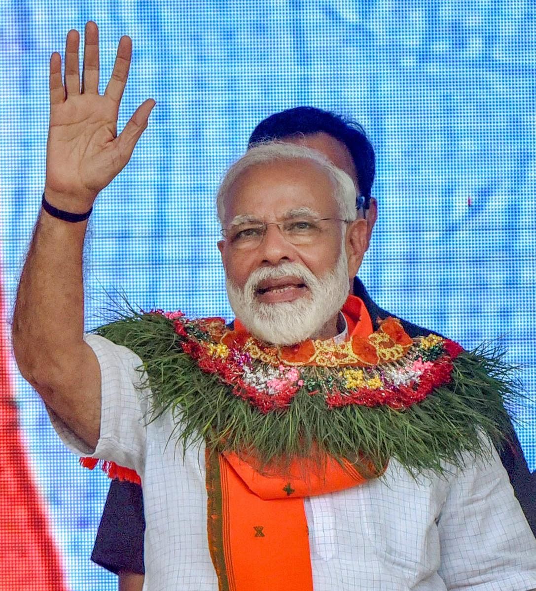 Prime Minister Narendra Modi waves at supporters during an election rally for Araria lok sabha constituency, in Forbesganj, Saturday, April 20, 2019. (PTI Photo)