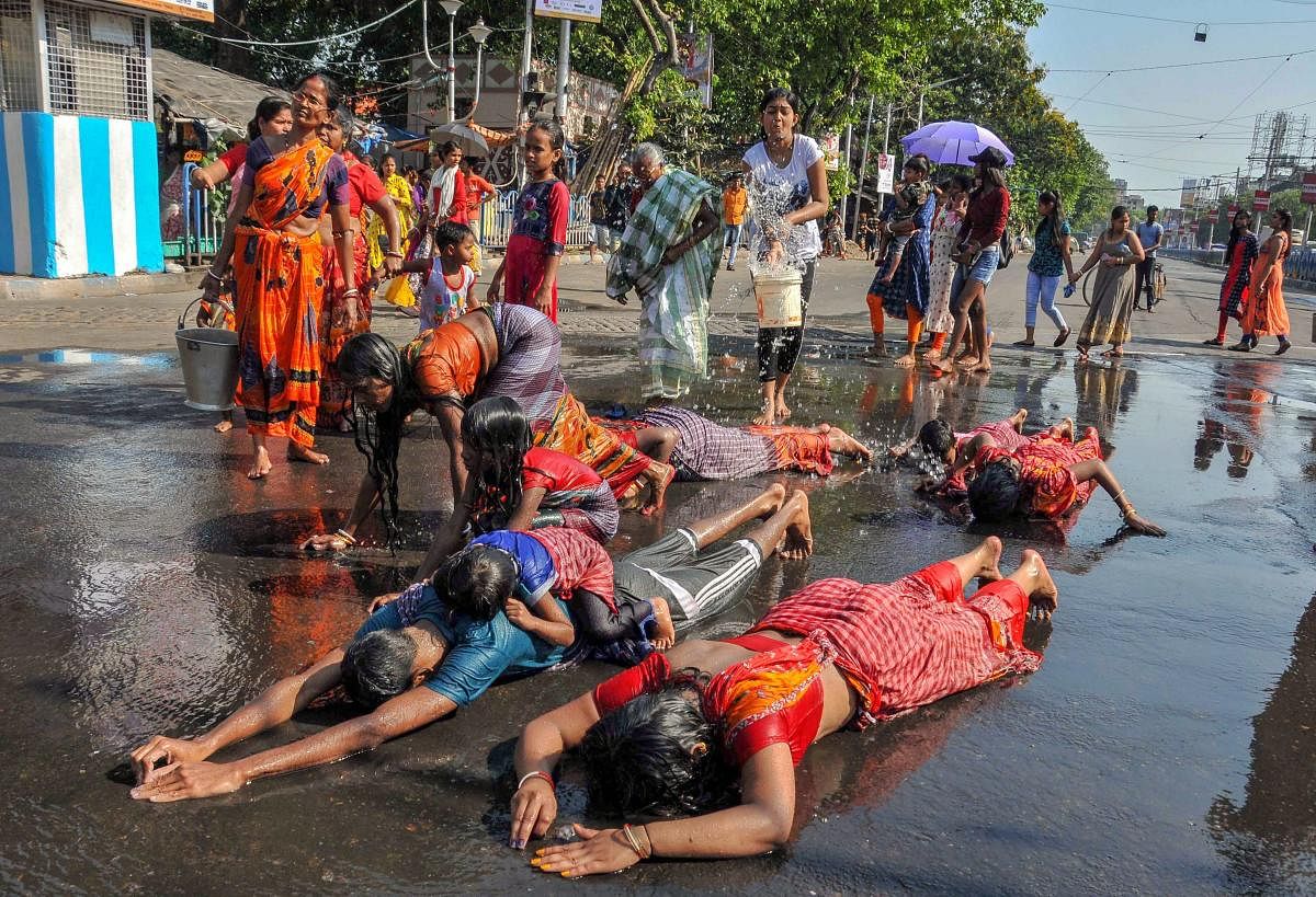 Devotees perform 'Dandi' rituals during 'Goddess Shitala Puja', in Kolkata, Saturday, April 20, 2019. (PTI Photo)
