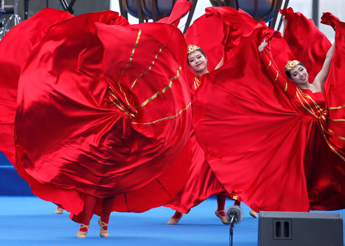 Performers dance at an event celebrating the 70th anniversary of the founding of the Chinese People's Liberation Army Navy (PLAN) in Qingdao, China, April 22, 2019. REUTERS/Jason Lee