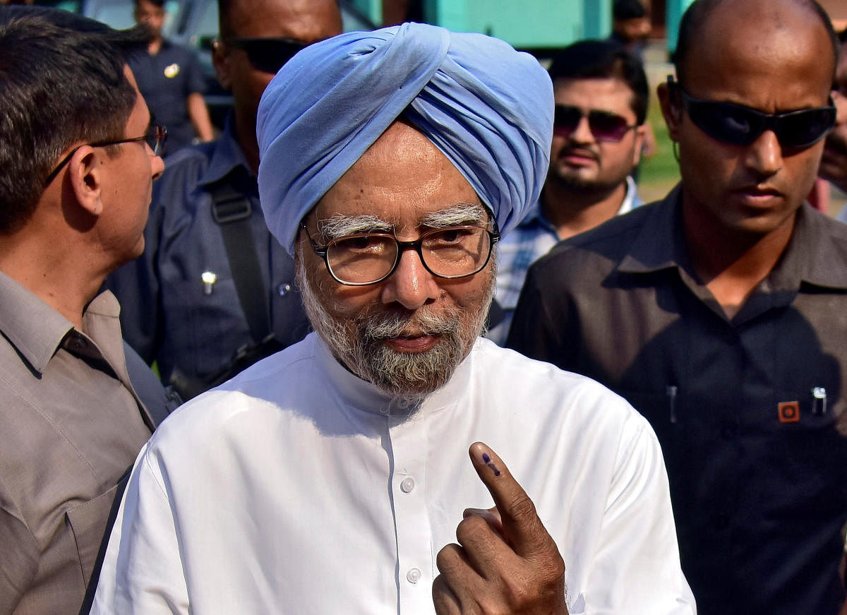 India's former Prime Minister Manmohan Singh shows his ink-marked finger after casting his vote at a polling station during the third phase of general election in Guwahati, India, April 23, 2019.