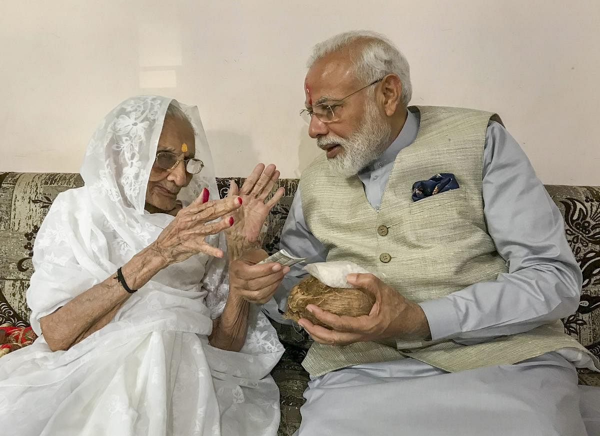 Prime Minister Narendra Modi being blessed by his nonagenarian mother Hiraba as he meets her before casting his vote, during the third phase of the 2019 Lok Sabha elections, in Gandhinagar, Tuesday, April 23, 2019. (PTI Photo)