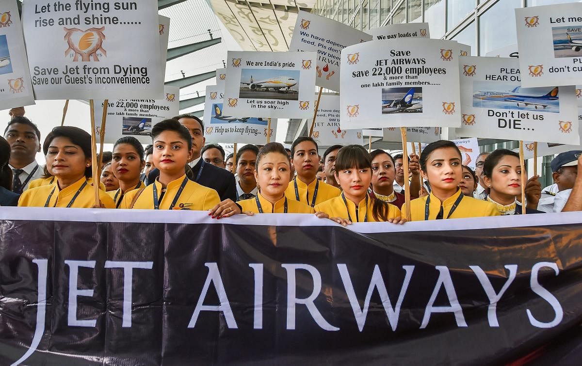 et Airways employees display placards as they gather to make an appeal for saving the cash-starved airline following the temporary shutdown of its operations, at NSCBI Airport in Kolkata, Wednesday, April 24, 2019. PTI Photo/Ashok Bhaumik)