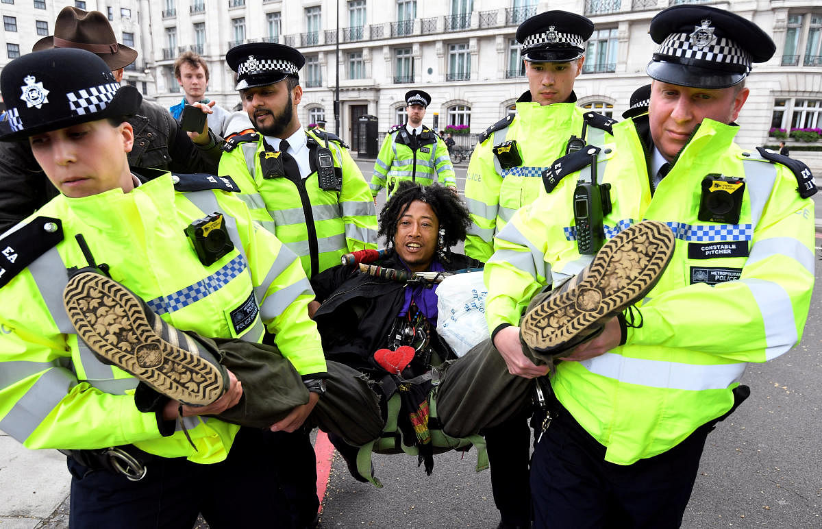 Members of the police carry a demonstrator during the Extinction Rebellion protest at the Marble Arch in London, Britain April 24, 2019. REUTERS/Toby Melville