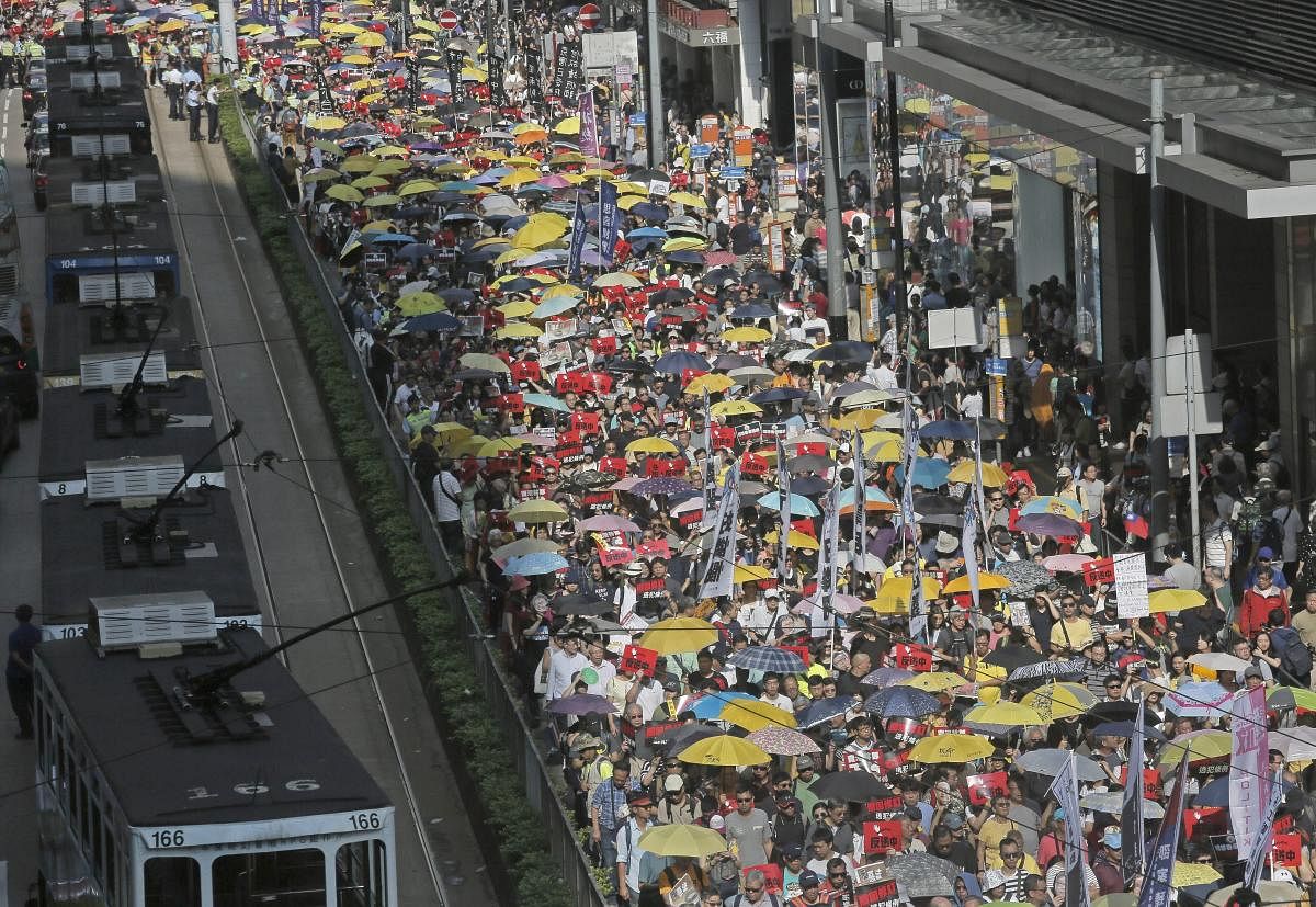 Thousands of protesters march along a downtown street against an extradition law in Hong Kong. (AP/PTI Photo)