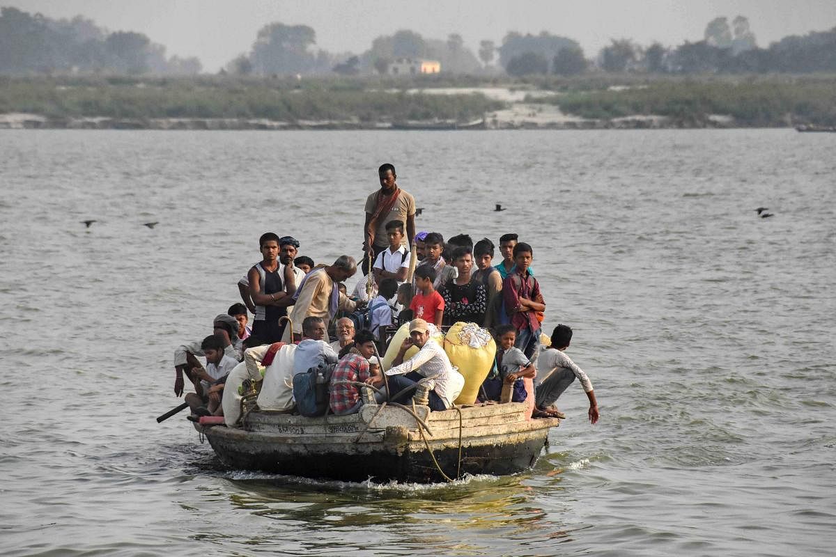 An overcrowded boat ferries passengers across river Ganga, in Patna. (PTI Photo)