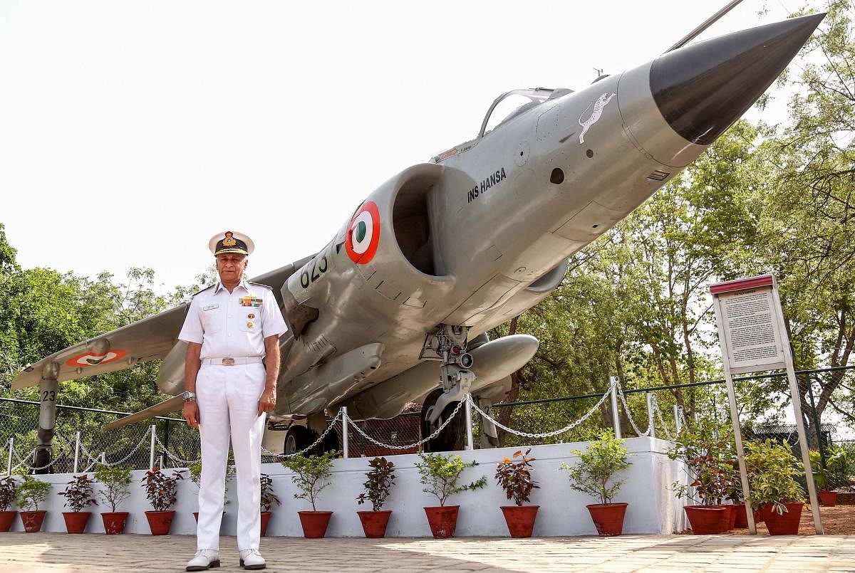 Indian Navy chief Admiral Sunil Lanba poses for photographs near the Sea-Harrier fighter aircraft at the Mayo College in Ajmer, Rajasthan. (PTI Photo)