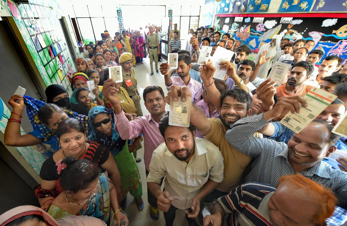 Voters stand in queues to cast their votes at Sangam Vihar polling station for the sixth phase of Lok Sabha polls, in New Delhi, Sunday, May 12, 2019. (PTI Photo)