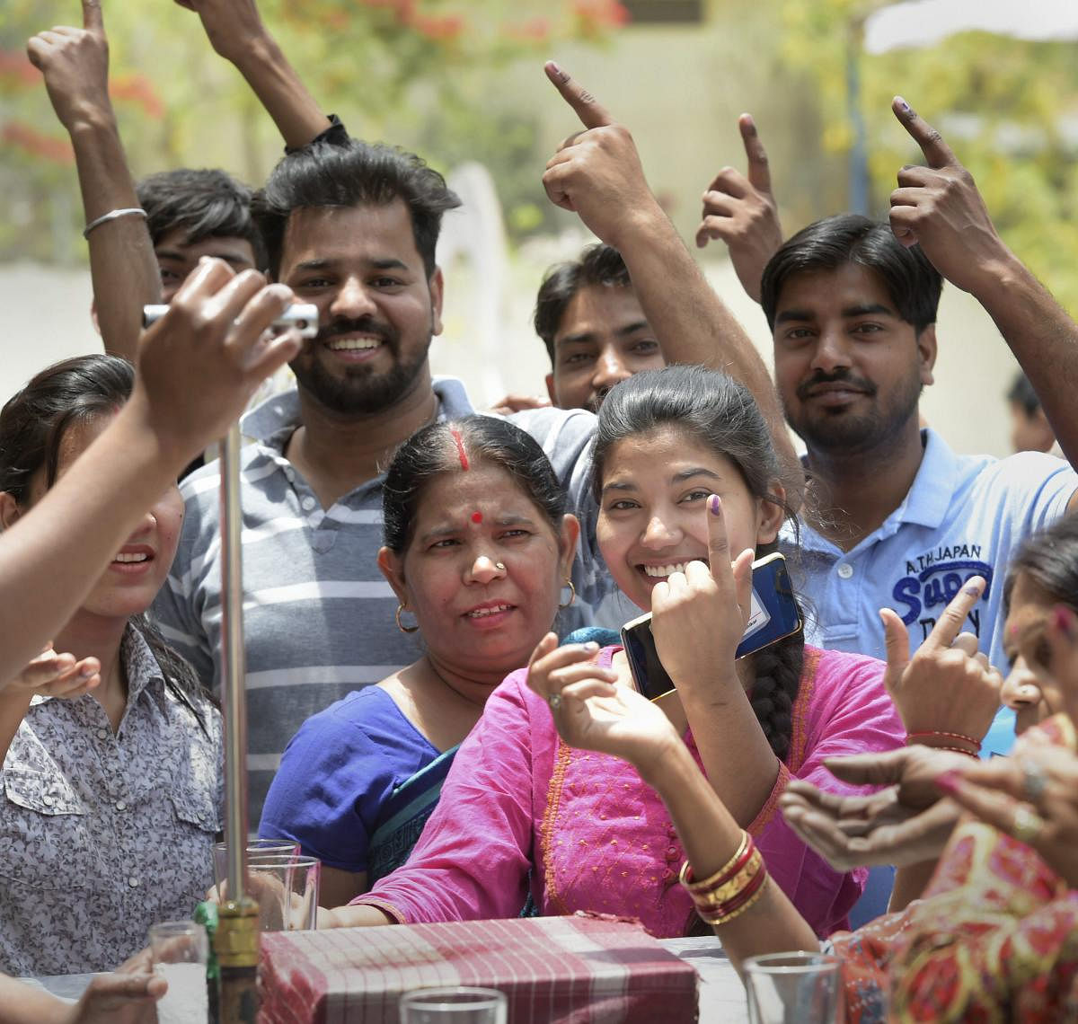 Voters show their fingers marked with indelible ink near a water counter, which was provided by the EC for the first time, at Sangam Vihar polling station for the sixth phase of Lok Sabha polls, in New Delhi, Sunday, May 12, 2019. (PTI Photo)