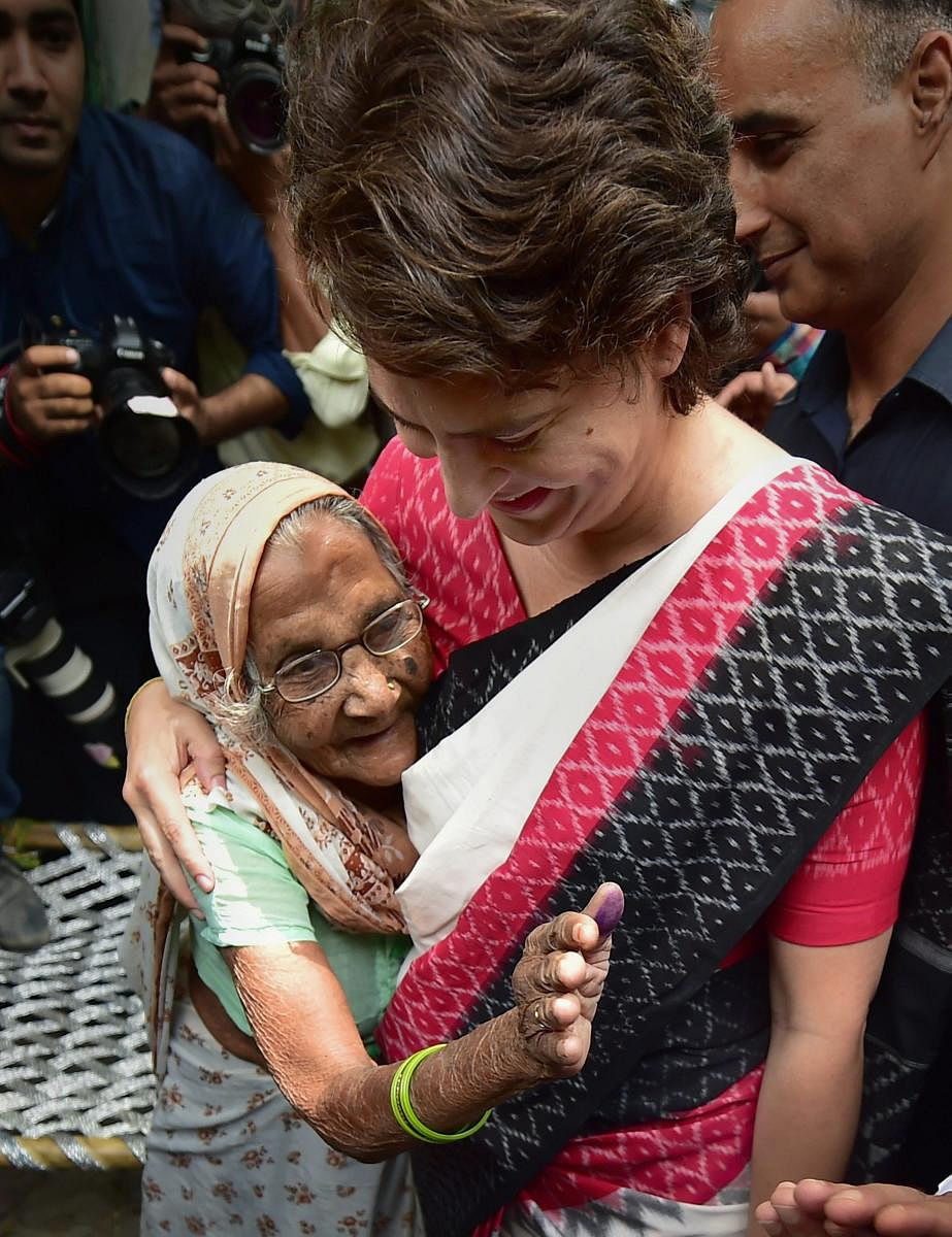 Congress General Secretary Priyanka Gandhi Vadra hugs an elderly voter after casting vote for the sixth phase of Lok Sabha elections, at polling station at Lodhi road in New Delhi, Sunday, May 12, 2019. (PTI Photo)