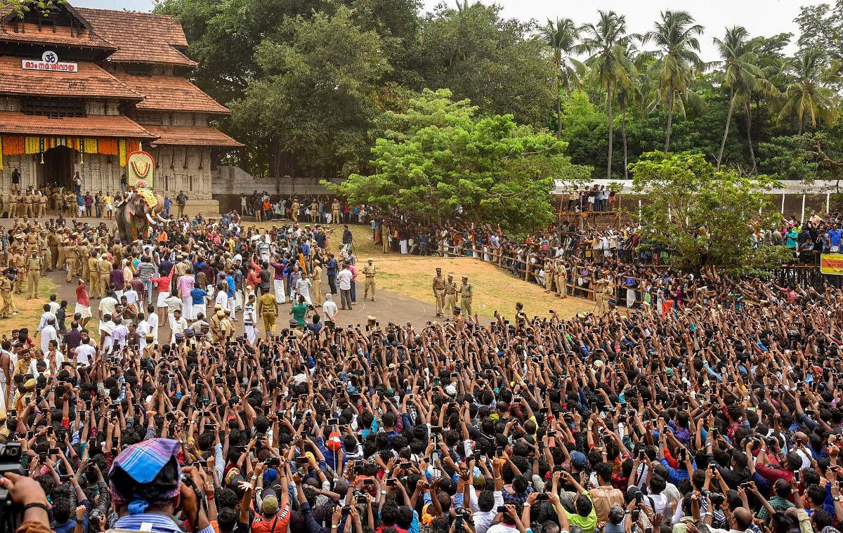 Devotees gather as elephant Thechikottukavu Ramachandran arrives to open the doors of the southern Gopuram of the Vadakkumnathan temple to formally begin the Thrissur Pooram festival, in Thrissur, Sunday, May 12, 2019. (PTI Photo)