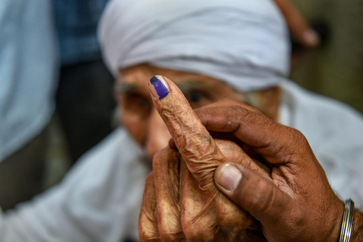 Bachan Singh, 111, the oldest voter in Delhi, leaves the polling booth after casting his vote for the sixth phase of the 2019 Lok Sabha elections in West Delhi, Sunday, May 12, 2019. (PTI photo)